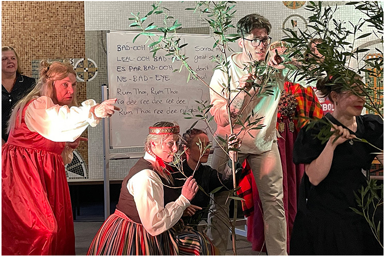 a group of actors stand behind shrubs in a scene from Dickens Street