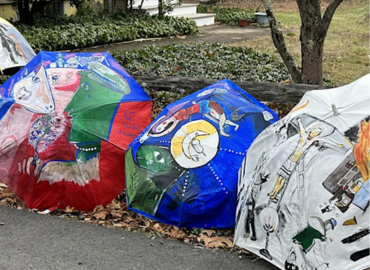 Three umbrellas painted with expressionistic art