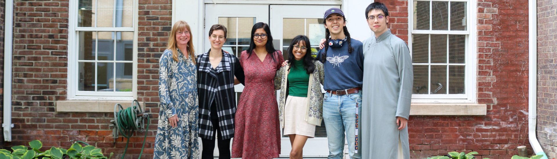 Professor T. Nikki Cesare Schotzko, Carmen Osahor, Sanyukta Mitra, Varsha Subramanian, Willow Martin, Andy Jin standing outside the Playhouse